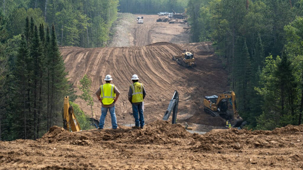 Construction workers in a forest being cleared