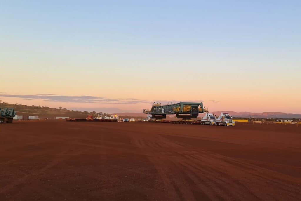 Mining trucks at sunset. Lewis Woolcott providing business advisory services to the resource sector.