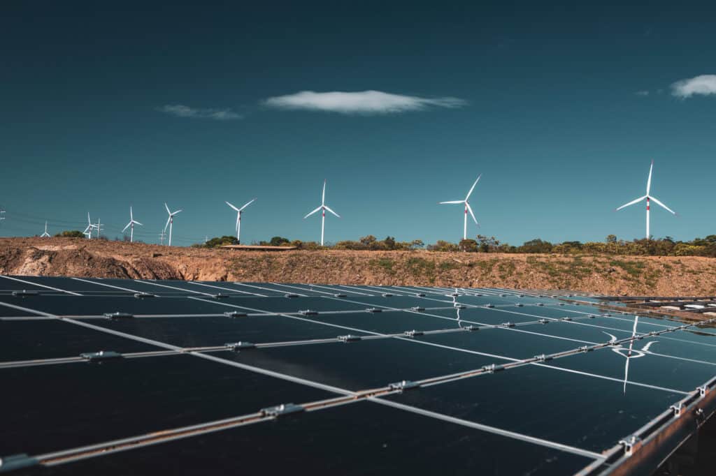 Renewable energy, solar panels and wind turbines.